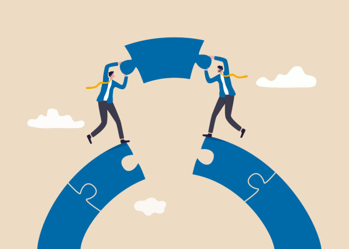 Business teamwork and partnership help to achieve team success, think together to solve business problem, business connection concept, businessmen working team building connect jigsaw puzzle bridge.